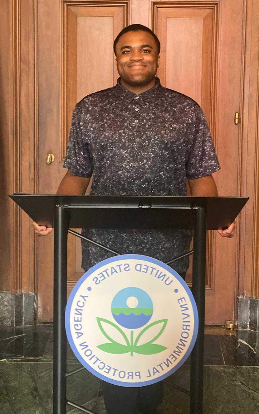 Xavier Smalls standing behind a lectern with the Environmental Protection Agency seal on it.